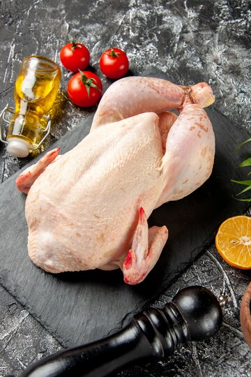 front-view-fresh-raw-chicken-with-tomatoes-light-dark-kitchen-meal-animal-photo-chicken-meat-color-farm-food_179666-44053